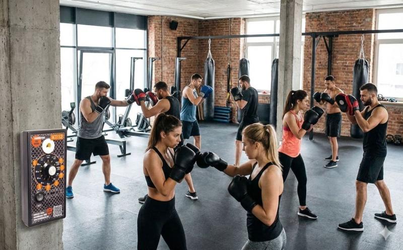 Dynamic boxing training in a modern gym: a group of motivated athletes in action ( (C) )