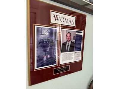 This professional plaque showcases Michael S. Bradley of M. Bradley Law Firm, featured in Sophisticated Woman magazine. The display highlights his recognition as a top legal professional, emphasizing his commitment to the principle of "And Justice For Al