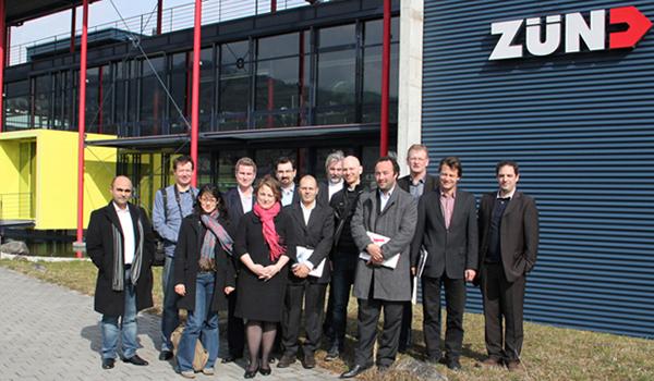 The editors-in-chief in front of the Zünd Systemtechnik AG Headquarter.