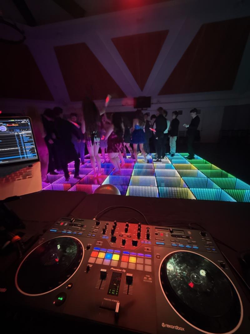 Corporate event DJ in Dallas providing interactive entertainment with LED dance floor, music, and crowd engagement during a high-energy company event.