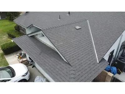 A newly installed asphalt shingle roof by Modern Roofing Inc. showcases clean lines and precise craftsmanship.