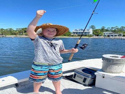 Book an unforgettable adventure with Showintail Inshore Charters Of Navarre Florida, the premier choice for navarre beach fishing guides. This visual captures the excitement of a successful catch on our comfortable boat. We specialize in family-friendly t