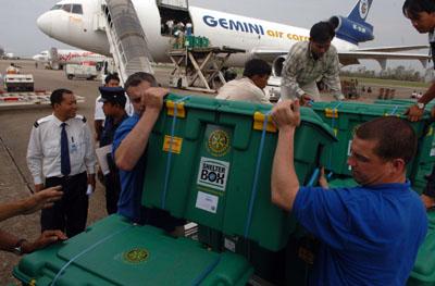 Shelterbox reponse team members Ian Neal and Terry Rea help unload 1000 aid boxes at the airport in Yangon Friday, 16. May.