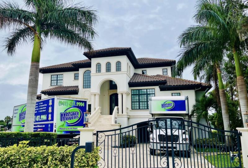 Master Movers moving trucks positioned outside a residential property in Venice, Florida, showcasing professional local moving services, residential relocation support, and trusted Florida movers assisting homeowners with a smooth moving experience.