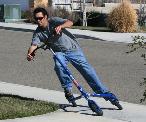 A commuter glides to work on the Trikke CV, the fuel-free, human-powered carving vehicle.