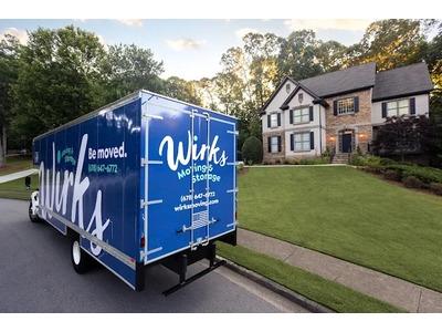 A Wirks Moving & Storage truck parked outside a beautiful Atlanta home, representing top-rated moving services in the area.