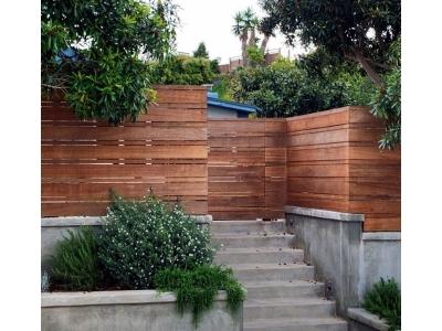 Quality Fence & Custom Outdoors showcases a sleek horizontal wood fence installation, blending privacy, durability, and modern curb appeal.