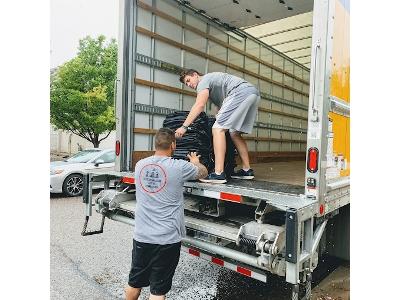 Evergreen Mtn Movers team members carefully load equipment onto a moving truck, demonstrating their dedication to safe and efficient moving services.
