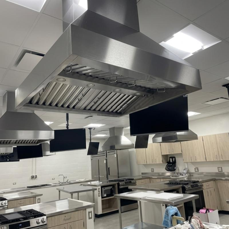 Proline PLJI 103 island range hoods were installed above student cooking stations during construction of a high school family and consumer sciences lab in Bartlett, Illinois.