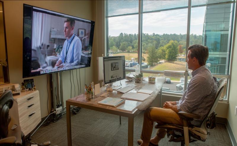 A man in rural office speaking with a doctor