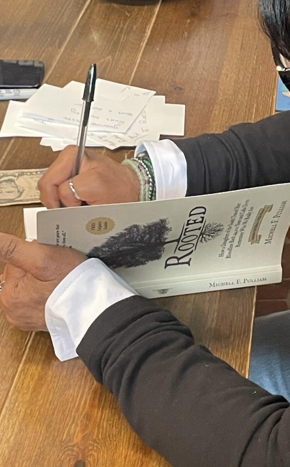 Michell F. Pulliam signs copies of Rooted during an author event at All Good Books in Columbia, South Carolina.
