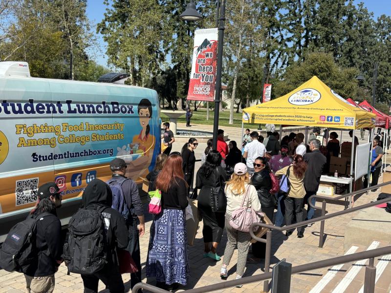 Students gather at the Student LunchBox distribution event, eagerly awaiting their turn to select fresh produce and groceries.