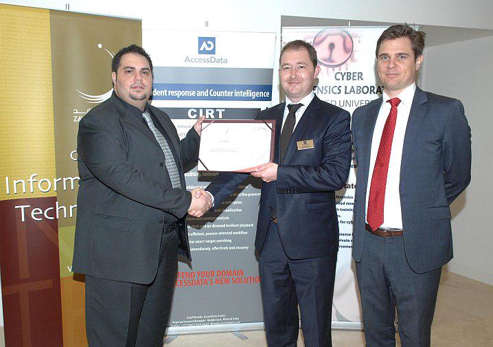 Dr. Ibrahim Baggili from Zayed University (L) presenting the ‘Friend of Zayed University’ certificate to AccessData executives