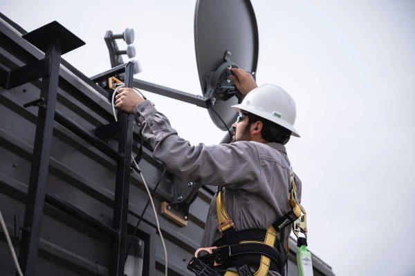 An EnerStar Solutions technician installs Starlink equipment, delivering reliable connectivity to schools, libraries, and healthca