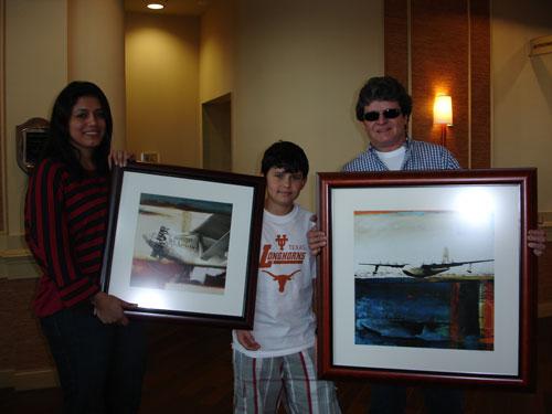 The Biesuz family (Val, Pedro and Eloy) show off their new artwork, "Spirit of St. Louis" and "Spruce Goose" from the Martin-Young