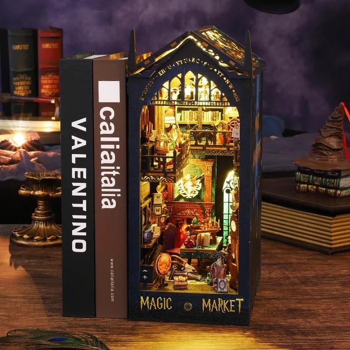 CozyCraft's Magic Market Book Nook illuminates a miniature fantasy world, featuring intricate gothic details and warm LED lighting