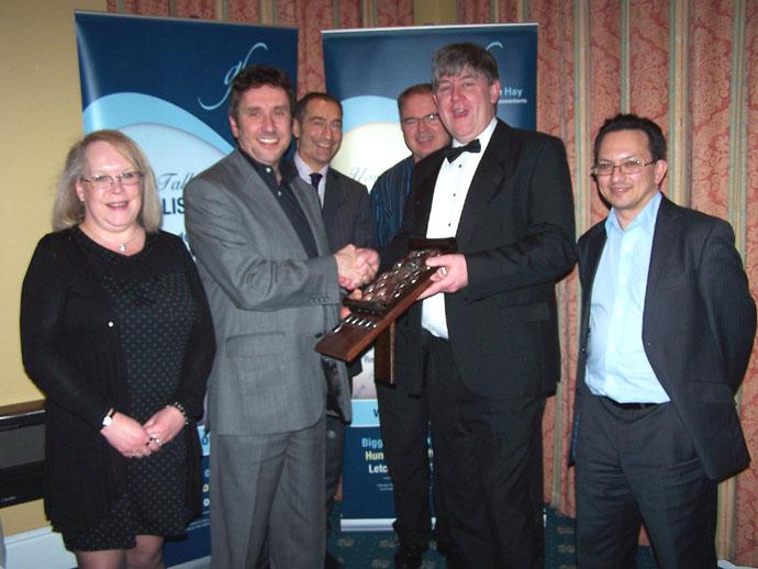 George Hay partner Barry Jefferd (right) presents George Hay Jubilee Shield to RHG managing director Paul Beasley