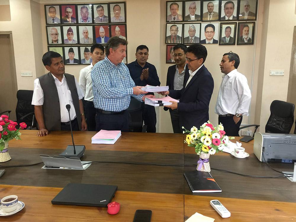 Dr. Beau Freeman of Lahmeyer signs the contract documents with Madhav Belbase, Joint Secretary of the WECS