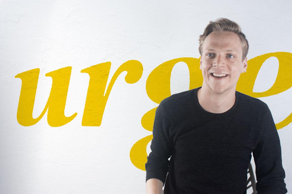 Brock Monahan sitting in the entranceway of the Urge's NYC studio, located in Long Island City, Queens.
