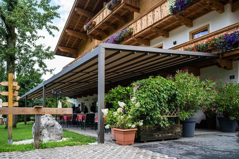 Awning manufacturer markilux has fitted a "pergola stretch" to the outdoor patio of the Oberhabach hotel in the Kitzbühl Alps.