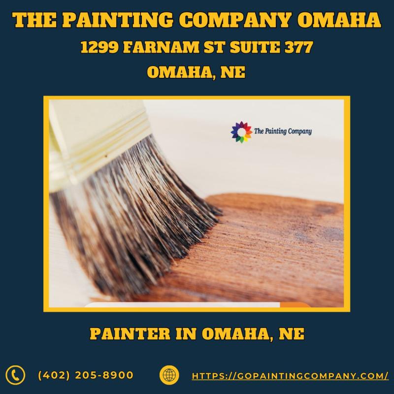 Painter in Omaha, NE - The Painting Company. An image featuring a professional team of painters from The Painting Company in action, meticulously working on a residential home in Omaha, NE. The photo captures their focus and attention to detail, emphasizi