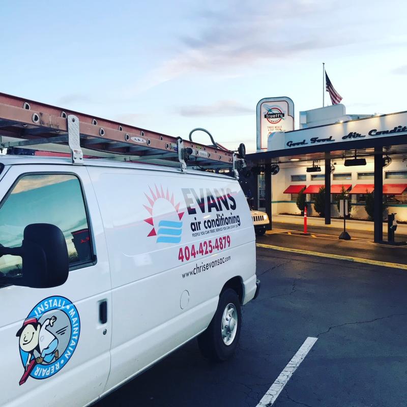 The van prominently displays the company's branding, logo, phone number, and website, emphasizing their commitment to reliable HVAC services.