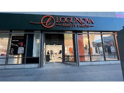 The salon's exterior features a wide, black awning with the name "LOGUNOVA BEAUTY SALON" displayed in elegant, three-dimensional copper-colored letters, including a distinctive circular logo. The glass entrance, marked with the street address "607 SOU