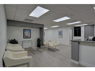 The image shows the clean, modern waiting area of a professional office, likely a legal or medical firm like SoCal Defense Lawyer's West Covina office.