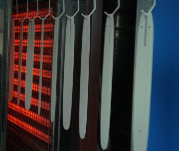 Powder coating on flat metal parts is cured quicker and on less floorspace than with a gas-fired oven.